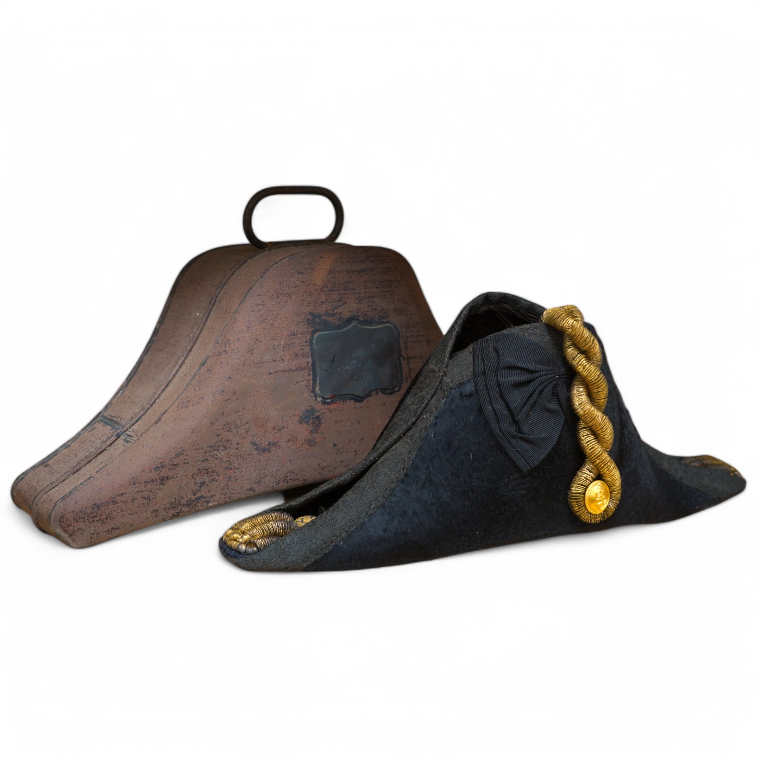 A Naval Lieutenant's bi-corn hat, in its tin case, with applied plaque for D. Donavon R.N. Condition - fair, with general surface rust to the case.
